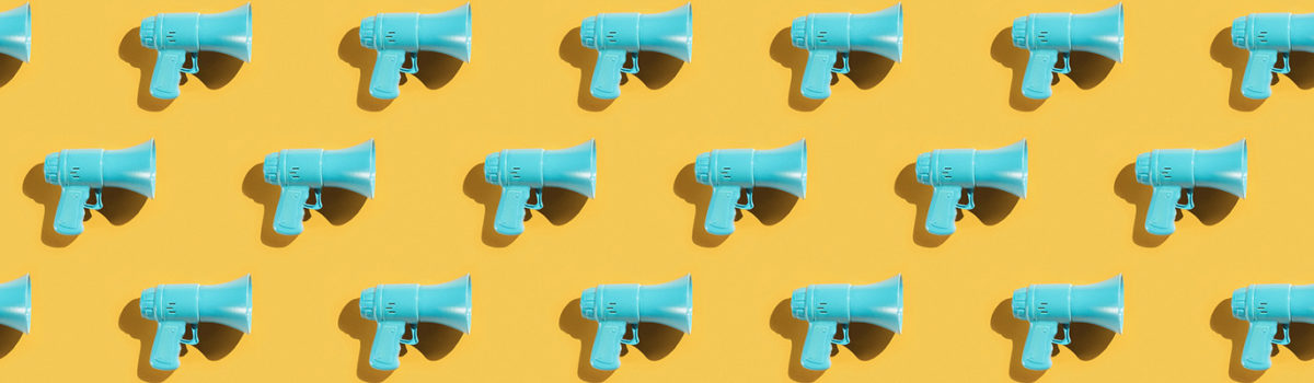 Stocksy Megaphones Blue On Yellow 1600X400 1 1200X350